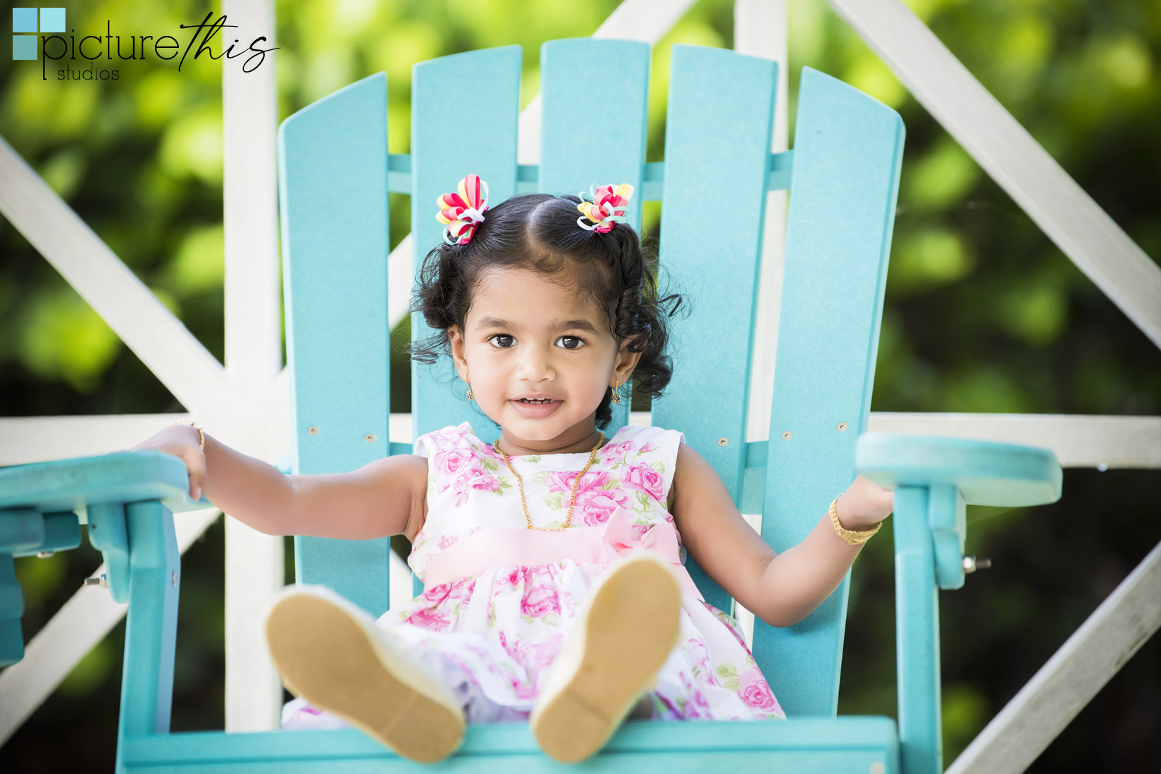 This beautiful little two year old celebrated with family portraits at The Cayman Islands Botanical Park by Heather Holt Photography with Picture This Studios