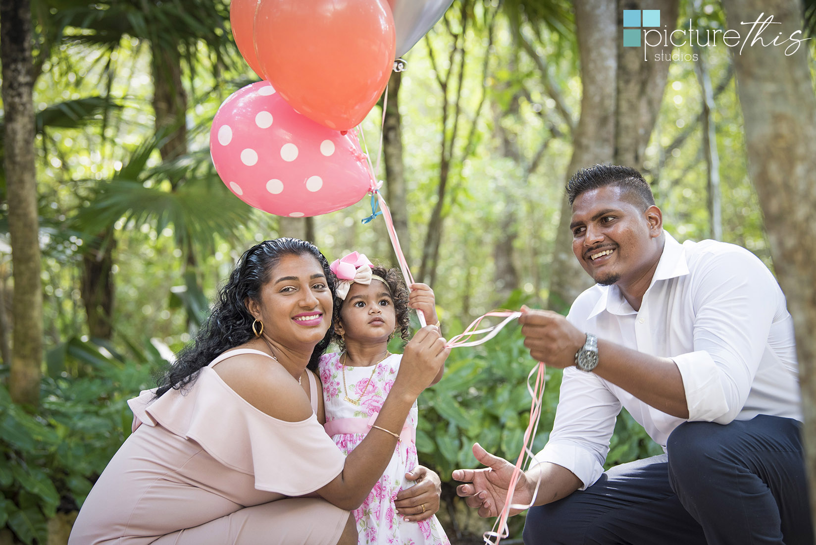 This beautiful little two year old celebrated with family portraits at The Cayman Islands Botanical Park by Heather Holt Photography with Picture This Studios