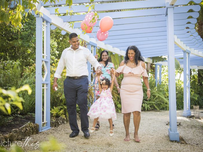 This beautiful little two year old celebrated with family portraits at The Cayman Islands Botanical Park by Heather Holt Photography with Picture This Studios.