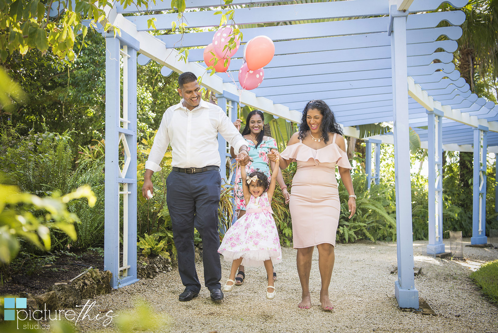 This beautiful little two year old celebrated with family portraits at The Cayman Islands Botanical Park by Heather Holt Photography with Picture This Studios