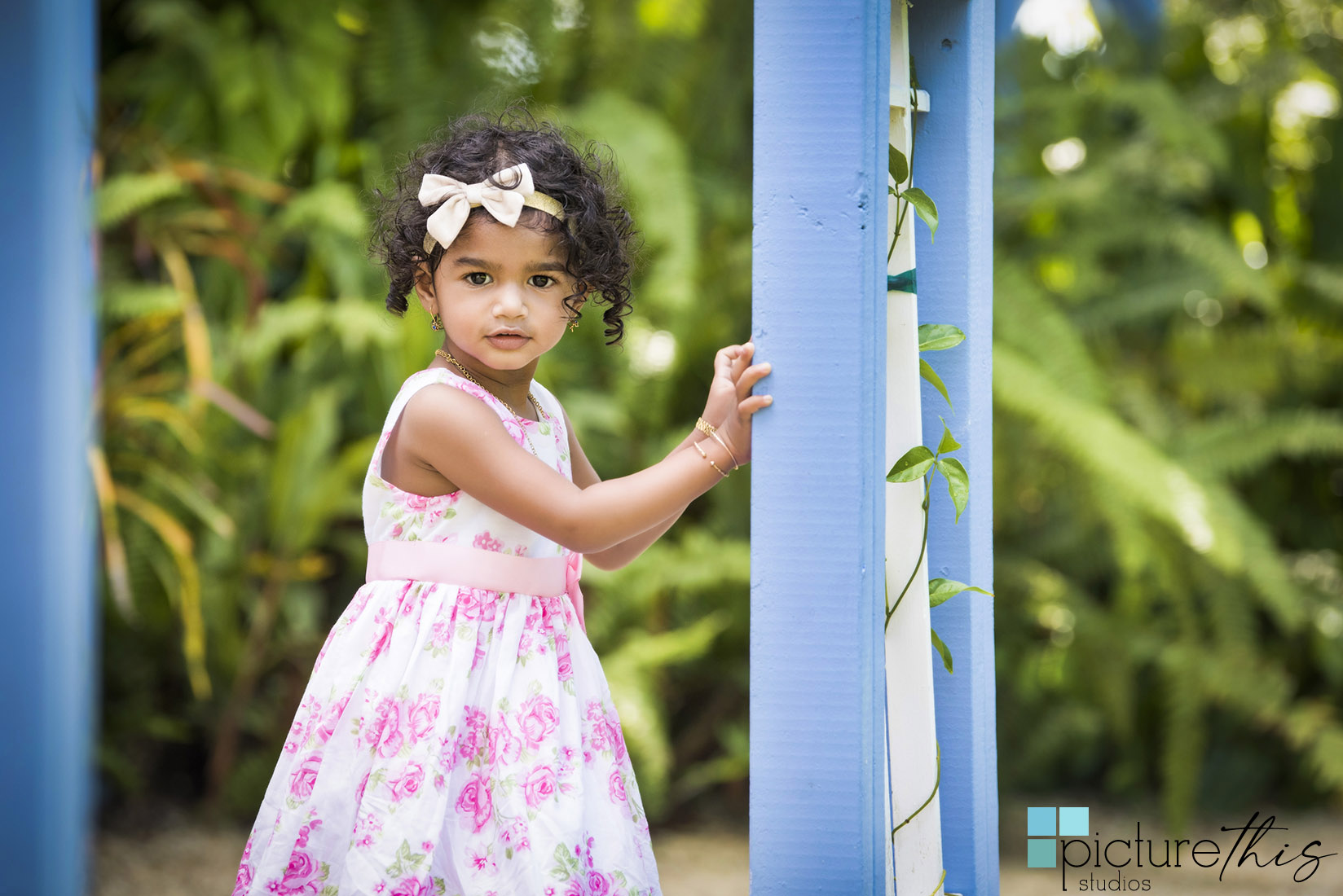 This beautiful little two year old celebrated with family portraits at The Cayman Islands Botanical Park by Heather Holt Photography with Picture This Studios