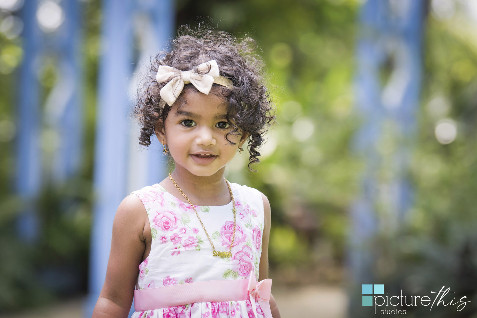 This beautiful little two year old celebrated with family portraits at The Cayman Islands Botanical Park by Heather Holt Photography with Picture This Studios