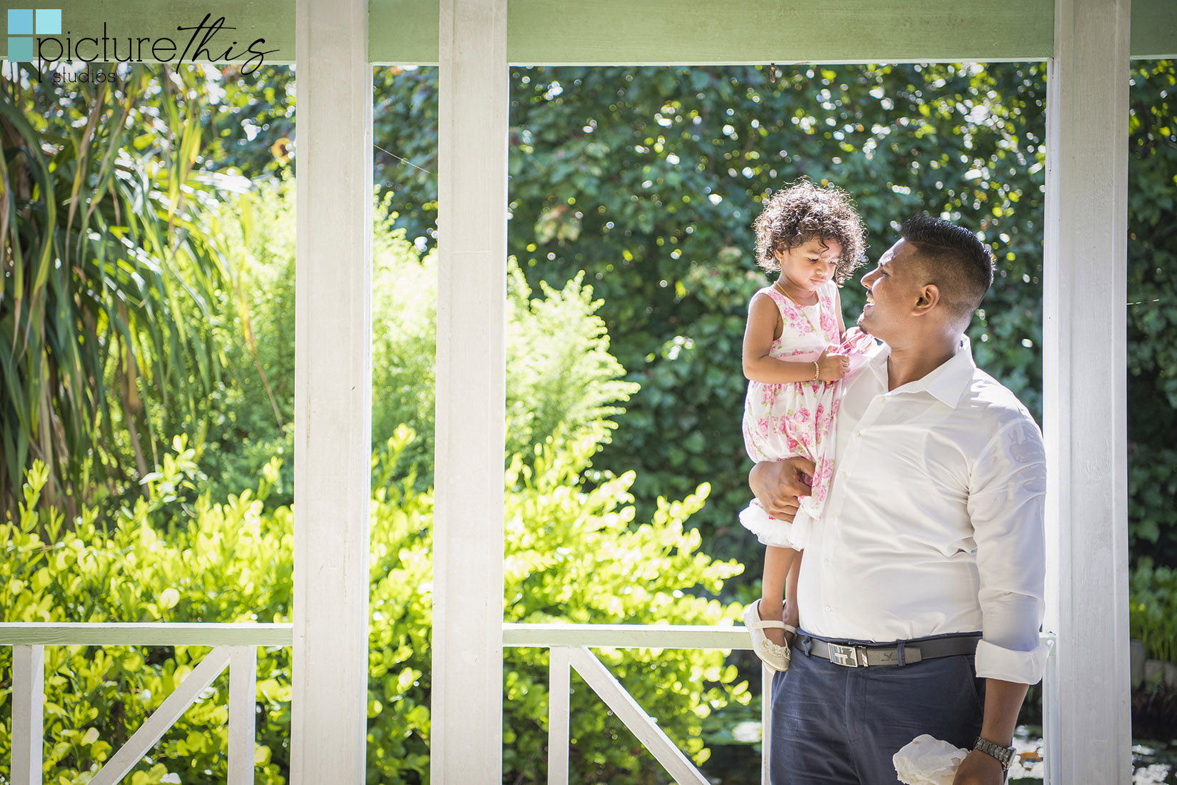 This beautiful little two year old celebrated with family portraits at The Cayman Islands Botanical Park by Heather Holt Photography with Picture This Studios