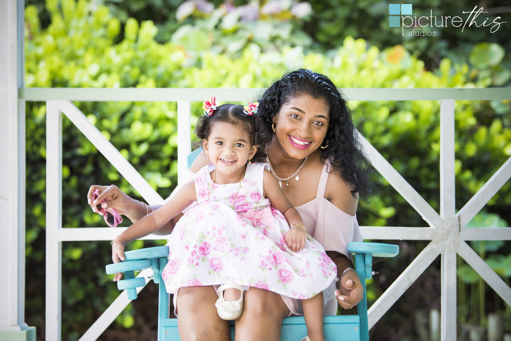 This beautiful little two year old celebrated with family portraits at The Cayman Islands Botanical Park by Heather Holt Photography with Picture This Studios